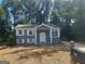 Charming home featuring a painted brick facade, white shutters, and a well-manicured lawn at 8427 Fredericksburg Ct, Jonesboro, GA 30238