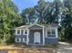 Charming home featuring a painted brick facade, white shutters, and a well-manicured lawn at 8427 Fredericksburg Ct, Jonesboro, GA 30238