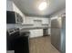 Updated kitchen features white cabinets, stainless steel appliances, and updated countertops at 8427 Fredericksburg Ct, Jonesboro, GA 30238