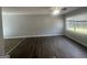 Spacious living room featuring new floors, large windows, and a ceiling fan at 8427 Fredericksburg Ct, Jonesboro, GA 30238