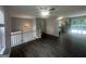 Open-concept living area featuring wood floors, staircase, modern chandelier, and an adjacent kitchen at 8427 Fredericksburg Ct, Jonesboro, GA 30238
