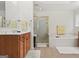 Bright bathroom featuring a soaking tub, separate shower, and a cherry wood vanity with a white countertop at 3688 Eagles Beek Cir, Lithonia, GA 30038