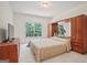 Bedroom with large window, neutral carpet, and built-in wooden storage and display features at 3688 Eagles Beek Cir, Lithonia, GA 30038