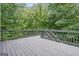 Large gray deck overlooking a backyard with mature trees at 3688 Eagles Beek Cir, Lithonia, GA 30038