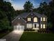 Stunning two-story brick home featuring a two-car garage, manicured lawn, and elegant architectural details at 3688 Eagles Beek Cir, Lithonia, GA 30038