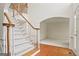 Foyer with white carpeted staircase and wood trim; white walls and hardwood floors at 3688 Eagles Beek Cir, Lithonia, GA 30038