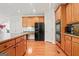 Spacious kitchen showcasing wood floors, stainless steel appliances, and a breakfast nook area at 3688 Eagles Beek Cir, Lithonia, GA 30038