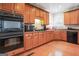 Kitchen with stainless steel appliances, wooden cabinets, and hardwood floors at 3688 Eagles Beek Cir, Lithonia, GA 30038