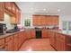 Bright kitchen features wood cabinets, center island, and a window over the sink offering natural light at 3688 Eagles Beek Cir, Lithonia, GA 30038