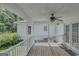 Enjoy outdoor living on the back porch, complete with a ceiling fan and wooden floors at 871 Clearwater Rd, Sharpsburg, GA 30277
