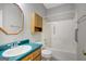 Functional bathroom with a combined shower and tub, vanity and cabinet storage at 871 Clearwater Rd, Sharpsburg, GA 30277