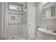 Updated bathroom boasts a tiled shower with grab bars and updated vanity at 871 Clearwater Rd, Sharpsburg, GA 30277
