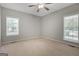 Neutral bedroom features two windows with blinds and a ceiling fan at 871 Clearwater Rd, Sharpsburg, GA 30277