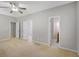 Bedroom featuring a ceiling fan, neutral walls, carpet, closets and natural light at 871 Clearwater Rd, Sharpsburg, GA 30277