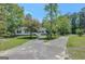 Attractive home with a long driveway, mature trees, and a well-kept front yard at 871 Clearwater Rd, Sharpsburg, GA 30277