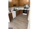 A kitchen featuring wood cabinets, stainless steel range and new flooring at 871 Clearwater Rd, Sharpsburg, GA 30277