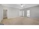 Open living room with neutral walls, carpet, fan and a view of the front door, perfect for entertaining at 871 Clearwater Rd, Sharpsburg, GA 30277