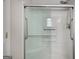 Modern shower with sliding glass doors, a built-in seat, and sleek fixtures at 871 Clearwater Rd, Sharpsburg, GA 30277