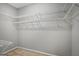 Organized walk-in closet with ample shelving space for storage solutions at 871 Clearwater Rd, Sharpsburg, GA 30277