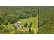 Overhead view reveals a home with pool and lush tree coverage surrounding it at 1828 Pitts Chapel Rd, Newborn, GA 30056