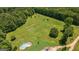 Aerial view of large lot with green grass and a fenced pool area at 1828 Pitts Chapel Rd, Newborn, GA 30056