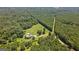 Aerial view of a home with a pool surrounded by dense trees at 1828 Pitts Chapel Rd, Newborn, GA 30056