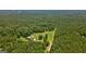 An expansive overhead view shows a house with a pool surrounded by dense trees at 1828 Pitts Chapel Rd, Newborn, GA 30056