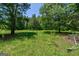 Heavily wooded backyard with mature trees, offering privacy and a natural outdoor environment at 1828 Pitts Chapel Rd, Newborn, GA 30056
