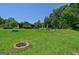Spacious backyard featuring an in-ground pool, fire pit, and ample green space, perfect for outdoor activities at 1828 Pitts Chapel Rd, Newborn, GA 30056