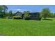 This spacious backyard with mature trees features an expansive lawn and a screened-in porch at 1828 Pitts Chapel Rd, Newborn, GA 30056