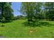 Large green backyard featuring mature trees, offering a serene and spacious outdoor environment at 1828 Pitts Chapel Rd, Newborn, GA 30056