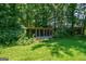 Green backyard featuring an enclosed structure and shed, adding functionality to the outdoor space at 1828 Pitts Chapel Rd, Newborn, GA 30056
