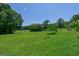 Expansive green backyard with mature trees, offering ample space and a serene outdoor environment at 1828 Pitts Chapel Rd, Newborn, GA 30056