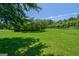 Expansive backyard with mature trees and lush green grass, perfect for outdoor activities at 1828 Pitts Chapel Rd, Newborn, GA 30056