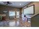 Basement area with a large projection screen, tiled floors, and access to the outdoors, great for entertainment at 1828 Pitts Chapel Rd, Newborn, GA 30056