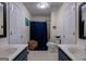 Bright bathroom with double sinks, a walk-in shower with curtain, and decorative accents at 1828 Pitts Chapel Rd, Newborn, GA 30056