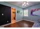 Bedroom with large chalkboard wall, window for natural lighting, and colorful artwork at 1828 Pitts Chapel Rd, Newborn, GA 30056