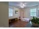 Bright bedroom with hardwood floors, complemented by a ceiling fan and natural light streaming through windows at 1828 Pitts Chapel Rd, Newborn, GA 30056