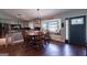 Open dining area features a built-in window seat, hardwood floors, and a view of the kitchen at 1828 Pitts Chapel Rd, Newborn, GA 30056