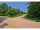 Paved road view of the private property, leading to a gated driveway at 1828 Pitts Chapel Rd, Newborn, GA 30056