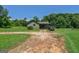 Charming green home with a well-maintained lawn, complemented by a pool and a parked SUV, creating a welcoming scene at 1828 Pitts Chapel Rd, Newborn, GA 30056