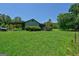 Ranch-style home features a covered carport and a screened-in porch overlooking a green lawn and trees at 1828 Pitts Chapel Rd, Newborn, GA 30056