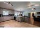 Open kitchen with tile floors, modern appliances, and a breakfast bar, seamlessly flowing into the living area at 1828 Pitts Chapel Rd, Newborn, GA 30056