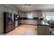 Well-lit kitchen featuring stainless steel appliances, tiled floors, and a cozy breakfast nook for casual dining at 1828 Pitts Chapel Rd, Newborn, GA 30056