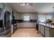 Functional kitchen with stainless appliances, tiled floor, and a sunlit window seat for a cozy dining experience at 1828 Pitts Chapel Rd, Newborn, GA 30056