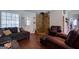 Spacious living room with hardwood floors, a stone accent wall, and comfortable seating at 1828 Pitts Chapel Rd, Newborn, GA 30056