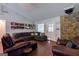 Cozy living room with a stone fireplace, hardwood floors, and comfortable seating, perfect for relaxation at 1828 Pitts Chapel Rd, Newborn, GA 30056