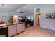 Open-concept living space with kitchen island, dining area and an inviting open door at 1828 Pitts Chapel Rd, Newborn, GA 30056