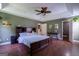 Bright and airy main bedroom with dark wood furniture and a tray ceiling at 1828 Pitts Chapel Rd, Newborn, GA 30056