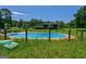 An inviting backyard pool surrounded by lush greenery offers a peaceful retreat and outdoor enjoyment at 1828 Pitts Chapel Rd, Newborn, GA 30056